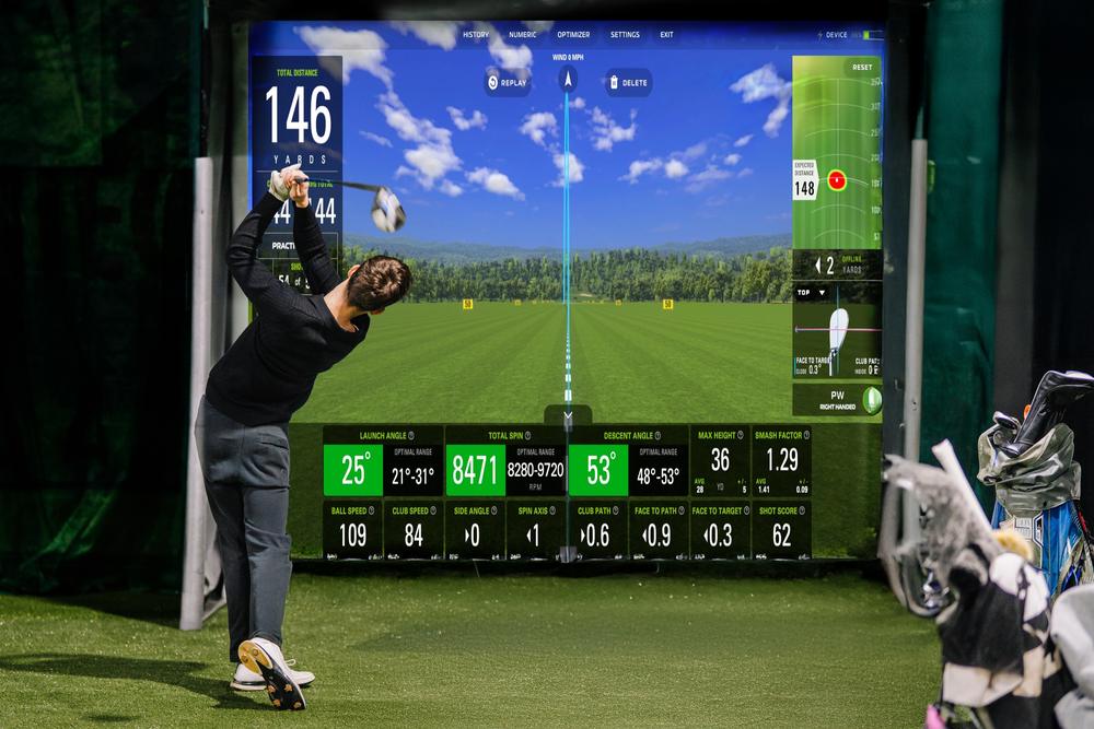 Launch monitor data on a golf simulator screen, calibrated for local elevation